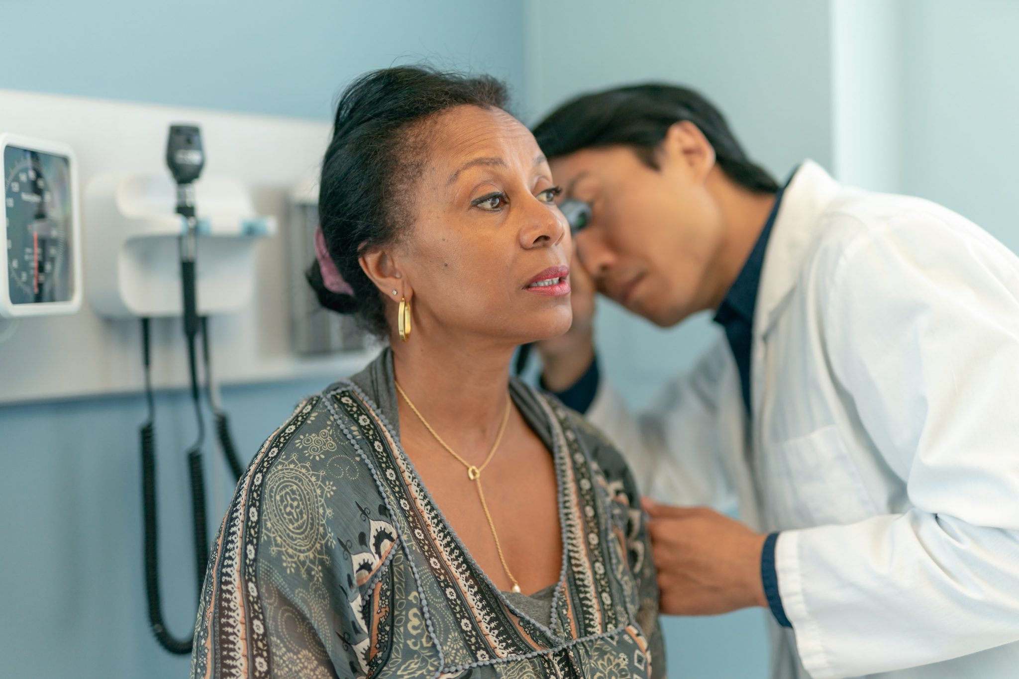 woman getting her ears checked by a doctor