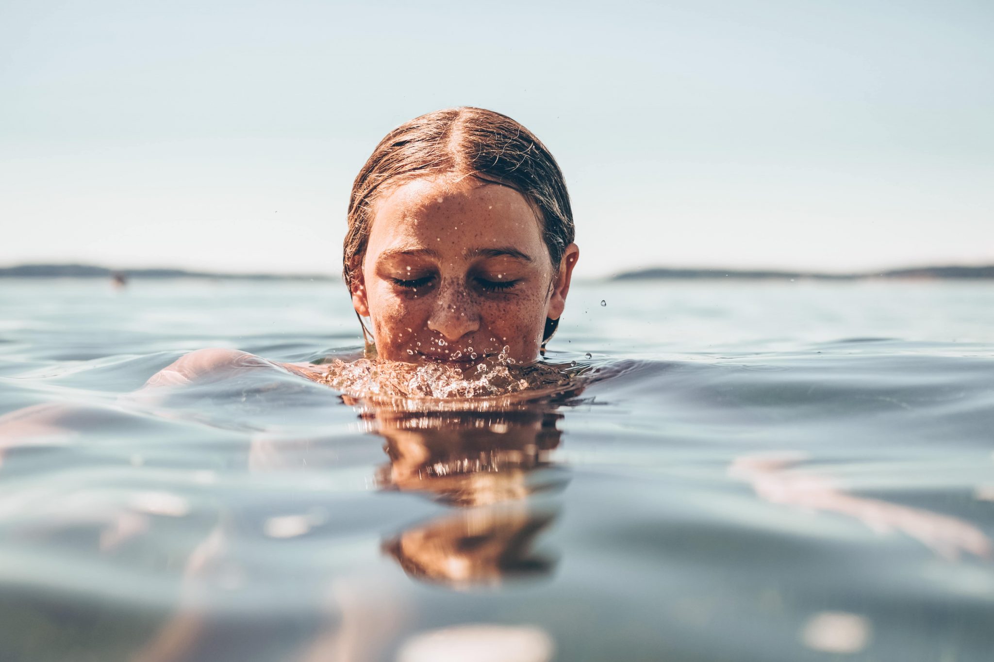 Woman with her head halfway in water